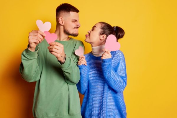 A co-habiting couple holding paper hearts, representing the importance of property rights and legal protection for unmarried partners