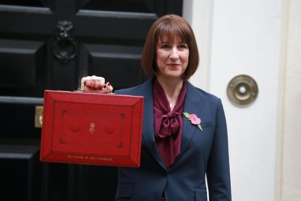 Rachel Reeves, UK Chancellor, holding the red Budget Box, symbolising the tax year-end and upcoming financial planning opportunities for 2025