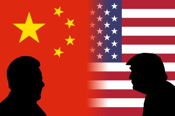 Donald Trump and Xi Jinping standing with U.S. and Chinese flags, symbolising trade tensions and their impact on global markets