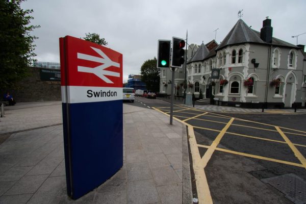 Swindon Train Station sign, highlighting the town’s strong transport links and property market appeal.