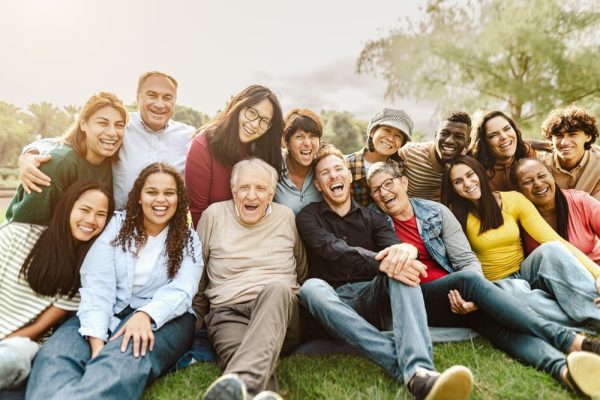 Happy multi-generational family outdoors, including grandparents, parents, and children, symbolising estate planning, wills, and securing financial futures