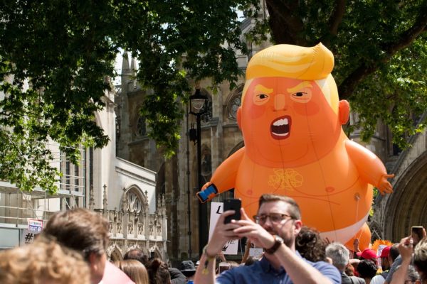 Inflatable orange balloon caricature of Donald Trump, symbolising market disruption and economic instability