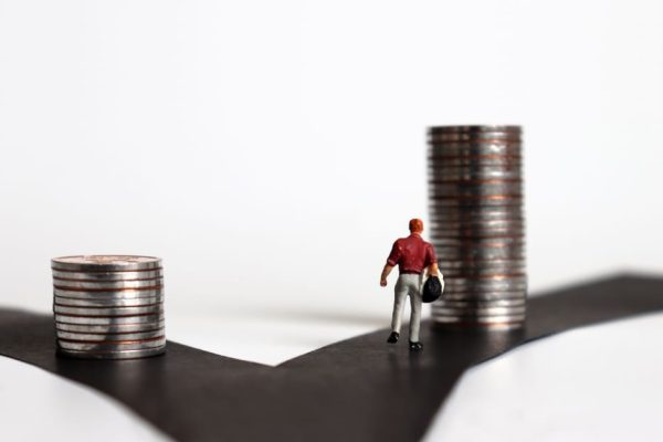 Person standing at a fork in the road, symbolising the choice between Cash ISA and Stocks & Shares ISA options in 2025