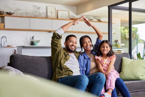 Young couple with their child sitting at home discussing fixed mortgage rates and future financial plans
