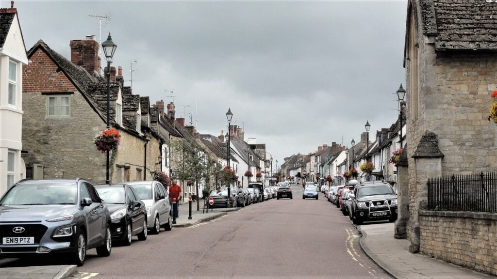 Cricklade High Street – The New Home of Mather & Murray Financial Cricklade High Street on a sunny day, lined with independent shops, historic buildings, and local businesses.