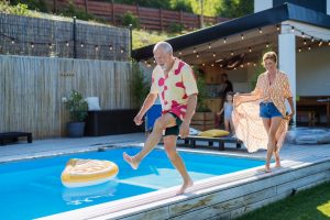 Retired couple enjoying a holiday by the pool