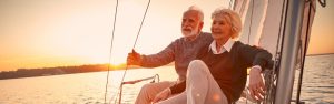 Older couple sailing on holiday during retirement
